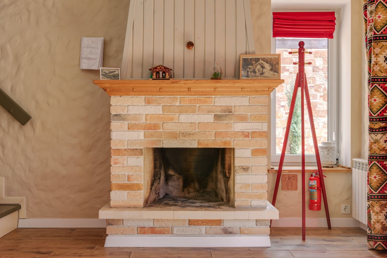 Brick fireplace firebox showing soot build-up before a professional chimney clean in Canterbury