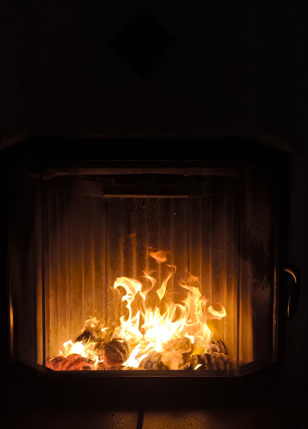 Wood burner fireplace with bright flames in a Christchurch home — chimney cleaning by Allan Cleaning Services
