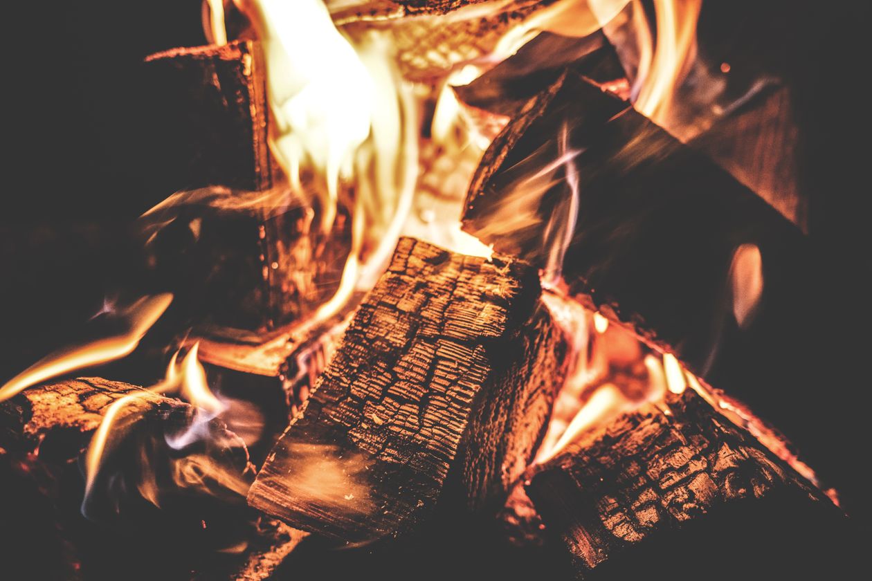 Close-up of firewood burning with tall flames in a fireplace
